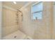 Tiled shower with a rainfall shower head, handheld wand, and a built-in bench at 13235 W Tether Trl, Peoria, AZ 85383