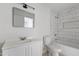 Bathroom with marble-style tiling and all white vanity, toilet and fixtures at 13804 N 52Nd Dr, Glendale, AZ 85306