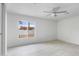 Spacious bedroom featuring a ceiling fan, large window and tile floors at 13804 N 52Nd Dr, Glendale, AZ 85306