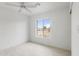 Bedroom features a ceiling fan, neutral paint and trim and a large window at 13804 N 52Nd Dr, Glendale, AZ 85306
