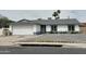 Single story home with a two-car garage, desert landscaping, and a walkway to the front door at 13804 N 52Nd Dr, Glendale, AZ 85306