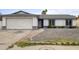 Charming single-story home with a two-car garage, gravel yard, and a welcoming front entrance at 13804 N 52Nd Dr, Glendale, AZ 85306