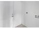 White hallway features a door, a electrical outlet, and neutral-toned flooring at 13804 N 52Nd Dr, Glendale, AZ 85306