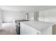 Spacious kitchen island featuring stone countertops, sleek cabinets, and cooktop in a bright, open space at 13804 N 52Nd Dr, Glendale, AZ 85306
