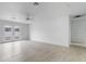Large, bright living room with tile floors, ceiling fan, and French doors leading to the backyard at 13804 N 52Nd Dr, Glendale, AZ 85306