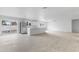 Open-concept living room with hardwood floors, white walls, and a kitchen island at 13804 N 52Nd Dr, Glendale, AZ 85306