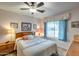 Bright bedroom with a comfortable bed and ceiling fan at 14300 W Bell Rd # 502, Surprise, AZ 85374