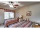 Guest bedroom with two twin beds and a ceiling fan at 14300 W Bell Rd # 502, Surprise, AZ 85374