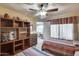 Bedroom with two twin beds, built-in shelving, and living room view at 14300 W Bell Rd # 502, Surprise, AZ 85374