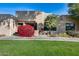 Charming stucco home with red flowers and manicured lawn at 14300 W Bell Rd # 502, Surprise, AZ 85374