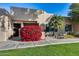 Tan stucco condo with red flowers and lush landscaping at 14300 W Bell Rd # 502, Surprise, AZ 85374