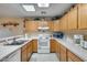 Bright kitchen with oak cabinets, white appliances, and a double sink at 14300 W Bell Rd # 502, Surprise, AZ 85374