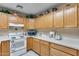 Efficient kitchen with light wood cabinets and modern appliances at 14300 W Bell Rd # 502, Surprise, AZ 85374