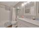 Bathroom with shower/tub combo, white vanity, and marble countertop at 14861 W Verde Ln, Goodyear, AZ 85395