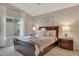 Guest bedroom with a queen-size bed and wood nightstands at 14861 W Verde Ln, Goodyear, AZ 85395