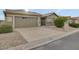 Single-story home with a two-car garage and landscaped front yard at 14861 W Verde Ln, Goodyear, AZ 85395