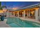 Stunning pool area with a covered patio and string lights at 14861 W Verde Ln, Goodyear, AZ 85395