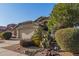 Tan house with nicely landscaped front yard and a two-car garage at 15268 W Melissa Ln, Surprise, AZ 85374