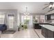 Modern kitchen with dark cabinets, a large island, and stainless steel appliances at 15268 W Melissa Ln, Surprise, AZ 85374