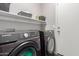 Bright laundry room, washer, dryer, and shelving at 15268 W Melissa Ln, Surprise, AZ 85374