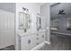 Elegant bathroom featuring a double vanity and modern lighting fixtures at 16351 W Yucatan Dr, Surprise, AZ 85388