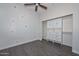 Bright bedroom with a floral accent wall and built-in closet at 16351 W Yucatan Dr, Surprise, AZ 85388