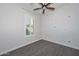 Charming bedroom with a floral accent wall and wood-look flooring at 16351 W Yucatan Dr, Surprise, AZ 85388