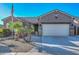 One-story house with desert landscaping, large driveway, and three-car garage at 16351 W Yucatan Dr, Surprise, AZ 85388