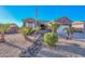 Charming curb appeal with a rock pathway, lush landscaping, and a three-car garage at 16351 W Yucatan Dr, Surprise, AZ 85388