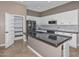 Modern kitchen with white cabinets, pantry, and granite countertops at 16351 W Yucatan Dr, Surprise, AZ 85388