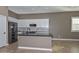 Modern kitchen with white cabinets, granite counters, and black appliances at 16351 W Yucatan Dr, Surprise, AZ 85388