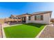 Artificial turf, brick patio, and a covered patio at 17022 W Echo Ln, Waddell, AZ 85355