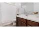 Bathroom with wood cabinets and white shower curtain at 17022 W Echo Ln, Waddell, AZ 85355