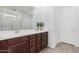 Modern bathroom with double vanity and a large mirror at 17022 W Echo Ln, Waddell, AZ 85355