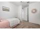 Small bedroom with pink bedding and an interior door at 17022 W Echo Ln, Waddell, AZ 85355