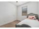 Small bedroom with gray bed frame and window blinds at 17022 W Echo Ln, Waddell, AZ 85355