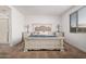 Bright and airy bedroom with a rustic wooden bed frame at 17022 W Echo Ln, Waddell, AZ 85355