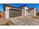 Two-car garage with brown doors and a long driveway at 17022 W Echo Ln, Waddell, AZ 85355