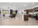 Open concept kitchen with island, stainless steel appliances, and dark wood cabinets at 17022 W Echo Ln, Waddell, AZ 85355