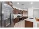 Modern kitchen with stainless steel appliances and dark wood cabinets at 17022 W Echo Ln, Waddell, AZ 85355