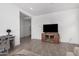 Living area with a large TV and a wooden media console at 17022 W Echo Ln, Waddell, AZ 85355