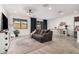 Open concept living and dining area with dark grey sofa at 17022 W Echo Ln, Waddell, AZ 85355