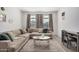 Living room featuring a sectional sofa and a coffee table at 17022 W Echo Ln, Waddell, AZ 85355