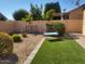 Landscaped backyard with gravel, artificial turf, and seating at 17449 N Fairway Dr, Surprise, AZ 85374