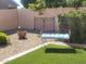 Landscaped backyard with gravel, artificial turf, and seating at 17449 N Fairway Dr, Surprise, AZ 85374