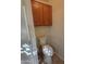 Convenient half-bathroom with a toilet and wood cabinets at 17449 N Fairway Dr, Surprise, AZ 85374