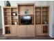 Large built-in entertainment center with ample storage at 17449 N Fairway Dr, Surprise, AZ 85374