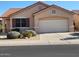 One-story house with tan exterior, tile roof, and landscaped front yard at 17449 N Fairway Dr, Surprise, AZ 85374