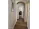 Clean hallway with wood-look flooring leading to a living area at 17449 N Fairway Dr, Surprise, AZ 85374