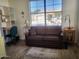 Home office features a couch, desk, built-in shelves, and wood flooring at 17449 N Fairway Dr, Surprise, AZ 85374